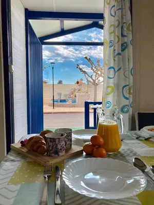 a table with a plate of bread and orange juice at Camping y Bungalows Monmar in Moncófar