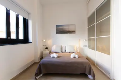 a bedroom with a large bed with two pillows at Valentia Apartments - Mercado Central in Valencia