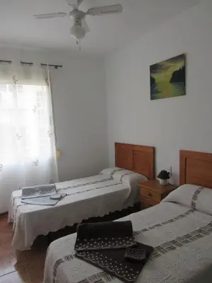 a room with three beds and a window at Apartamento Playa Malvarrosa, Valencia in Valencia