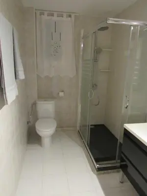 a bathroom with a toilet and a glass shower at Apartamento Playa Malvarrosa, Valencia in Valencia