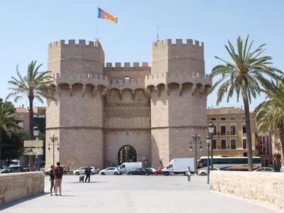 a large castle with a flag on top of it at ApartUP L' Almoina in Valencia