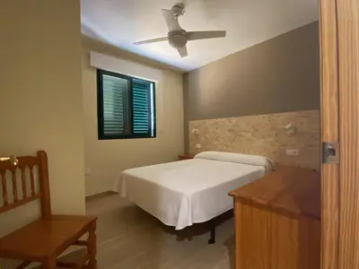a bedroom with a bed and a ceiling fan at Apartamentos Satse Moncofa in Moncófar