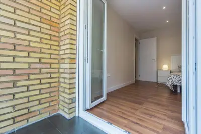 a room with a brick wall and a glass door at Cedro flat in Valencia