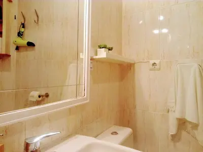 a bathroom with a sink and a toilet and a mirror at Apartamento céntrico Torres de Quart. in Valencia