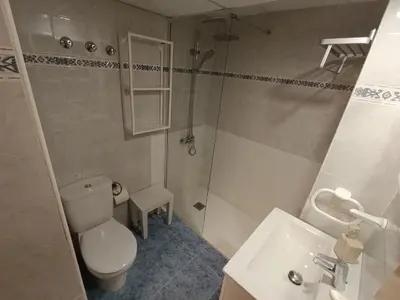 a bathroom with a toilet and a shower and a sink at ValenciaBeachHome in Port Saplaya