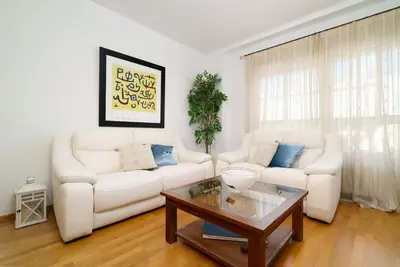 a living room with two white couches and a coffee table at Vivaldi Valencia in Valencia