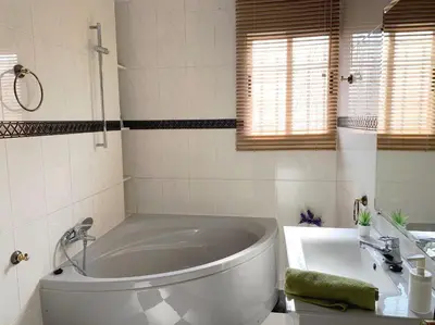 a white bathroom with a tub and a sink at Alto Palancia Calle Progreso 25 Sot de Ferrer in Sot de Ferrer