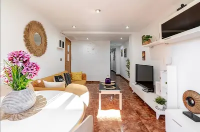 a living room with a couch and a tv at My House in Valencia