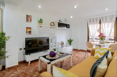 a living room with a couch and a tv at My House in Valencia