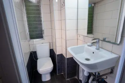 a bathroom with a white toilet and a sink at Hostal On Dormire Valencia in Valencia