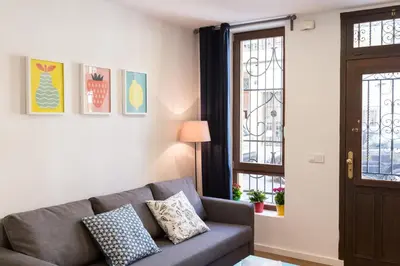 a living room with a couch and a window at Cabanyal Home in Valencia