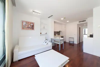 a living room with a white couch and a table at Ático Valencia Centro in Valencia