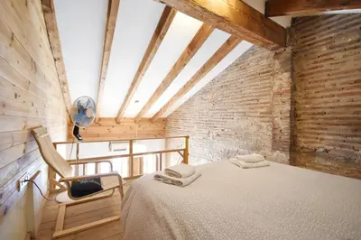 a bedroom with a bed in a room with a window at Apartamento en casa historica en la playa in Valencia