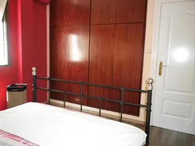 a bedroom with a bed and a wooden wall at AA la Nueva Fe in Valencia