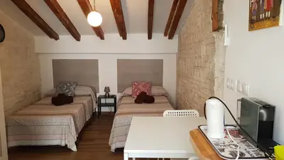 a room with two beds and a desk with a computer at PLAZA REDONDA brugada home in Valencia
