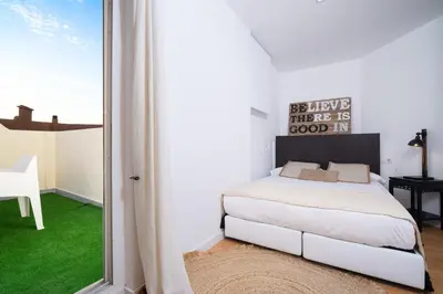 a bedroom with a bed and a sliding glass door at Valencia Luxury - Boutique Market in Valencia