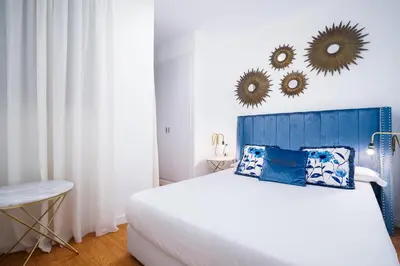 a bedroom with a blue and white bed and mirrors at Valencia Luxury - Boutique Market in Valencia