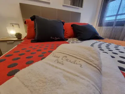 a bed with a blanket on top of it at Apto en Ciudad de las Ciencias y cerca playa in Valencia