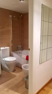 a bathroom with a toilet and a bath tub at Apto en Ciudad de las Ciencias y cerca playa in Valencia