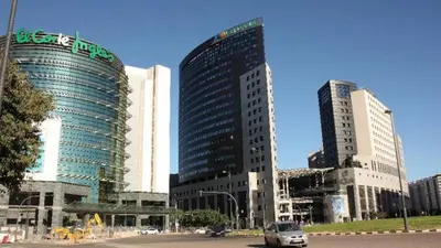 two tall buildings in a city with a car at Apto en Ciudad de las Ciencias y cerca playa in Valencia