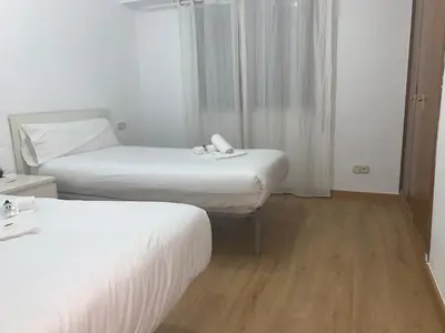 a hotel room with two beds and a window at Zerka Centro in Valencia