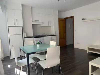 a kitchen and dining room with a table and chairs at Zerka Centro in Valencia