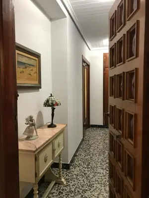 a hallway with a desk with a lamp on it at Bonito piso en el centro de Benaguacil in Benaguacil