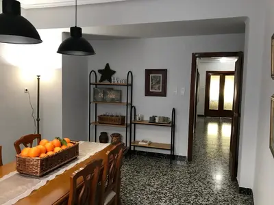 a dining room with a table with a basket of oranges at Bonito piso en el centro de Benaguacil in Benaguacil