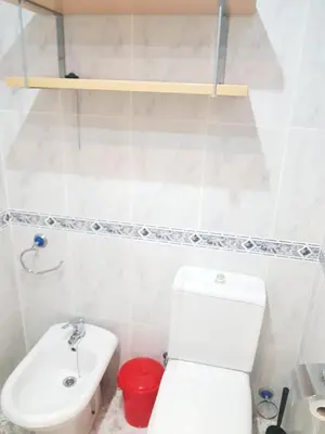 a bathroom with a white toilet and a sink at Isabel in Valencia