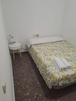 a bedroom with a bed and a small table at Isabel in Valencia