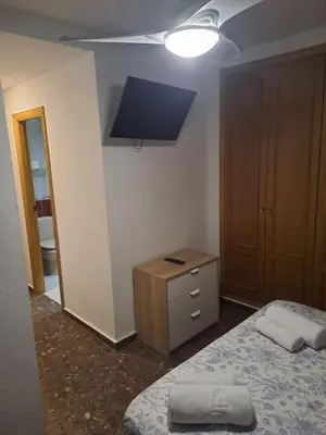a bedroom with a bed and a dresser and a light at Isabel in Valencia