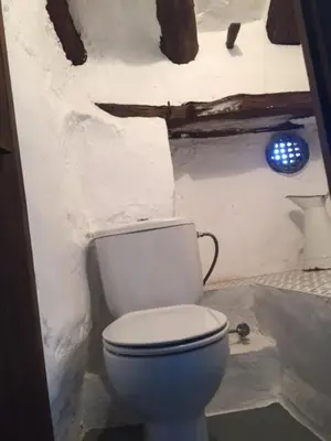 a bathroom with a toilet in a room at Casa Rural La Antigua in Chelva