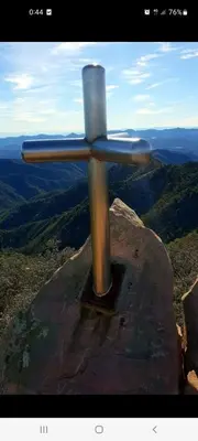 a metal cross on the top of a mountain at Casa rural La Senyora in Veo