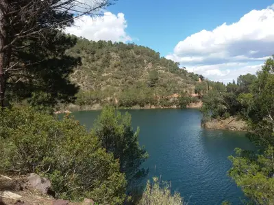 a lake in the middle of a mountain at Casa rural La Senyora in Veo