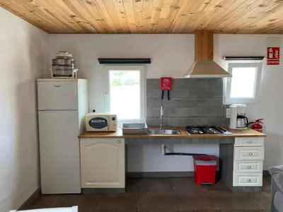 a kitchen with a white refrigerator and a sink at Casa Robion in Godelleta