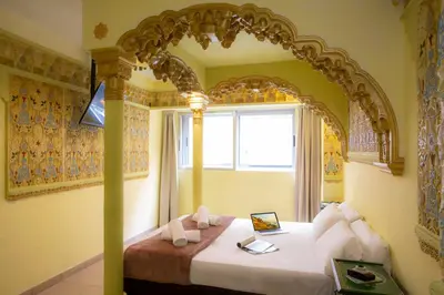 a bedroom with a bed with an ornate headboard at Casual Civilizaciones Valencia in Valencia