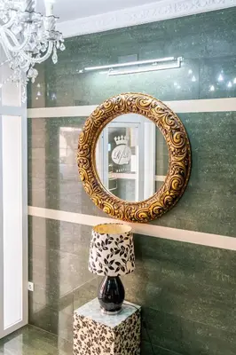 a mirror on a wall with a table and a lamp at Hostal RR Feria by Beleret in Valencia