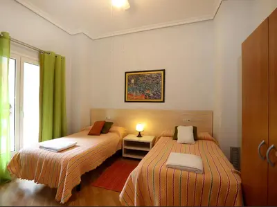 a bedroom with two beds and a window at Reino de Valencia Apartments in Valencia