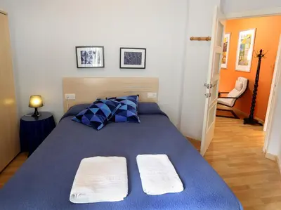 a bedroom with a blue bed with two towels on it at Reino de Valencia Apartments in Valencia