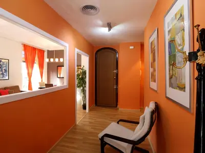a hallway with orange walls and a chair in a room at Reino de Valencia Apartments in Valencia