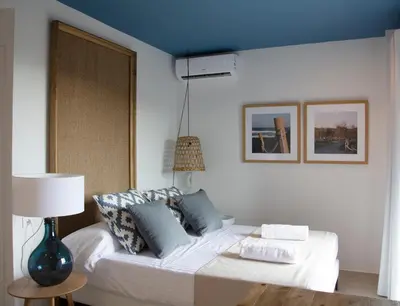 a bedroom with a bed with a blue ceiling at YOU & CO. Saler Beach Boutique in Valencia