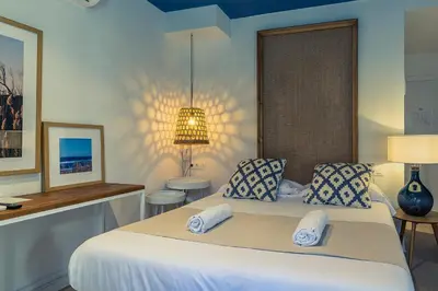 a bedroom with a large white bed with two pillows at YOU & CO. Saler Beach Boutique in Valencia