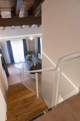 a room with a staircase and a living room at Old Town Flats Casa Burguerini in Valencia