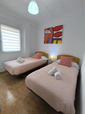 two beds in a room with a window at Valencia Central Apartment two bedrooms for Rent from more than 10 days in Valencia