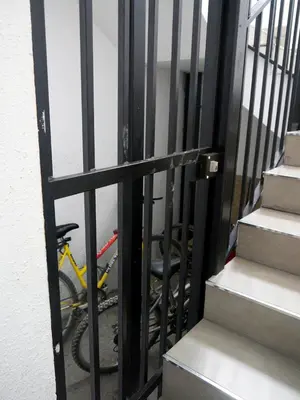 a bike is parked behind a gate next to some stairs at MARIETA in Valencia