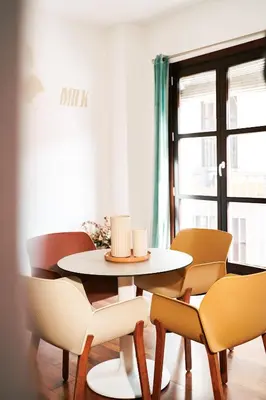 a table and chairs in a room with a window at Happy Apartments Valencia in Valencia