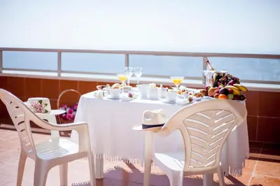a table with a bowl of fruit and drinks on a cruise ship at Apartamentos Florazar II Ajhory in Cullera