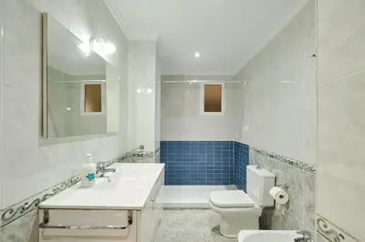 a bedroom with a bed and a desk and a mirror at Atarazanas Flat in Valencia