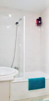 a white bathroom with a shower and a sink at APARTAMENTO CERCA DE PLAYA Y MONTAÑA IDEAL FAMILIAS O RELAX in Puzol