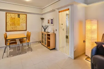 a living room with a table and chairs at Penthouse Inlakesh in Valencia